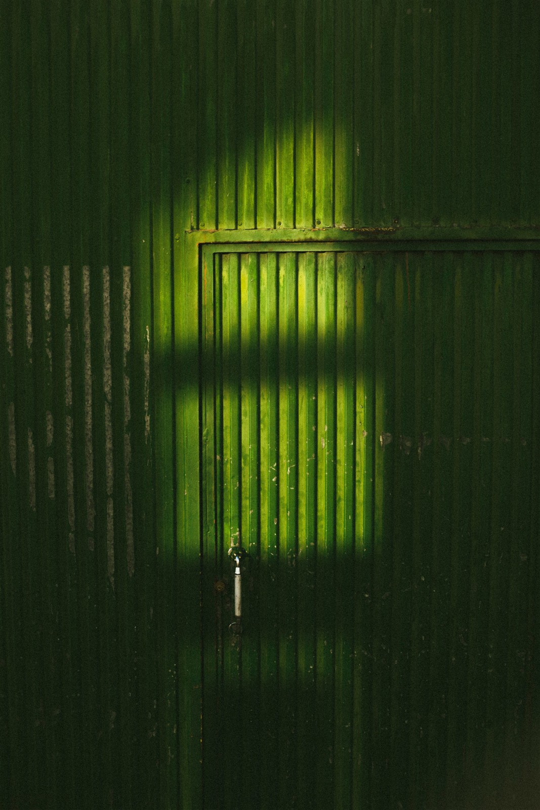 Foto de referencia de puerta metálica verde; no es un trabajo del taller